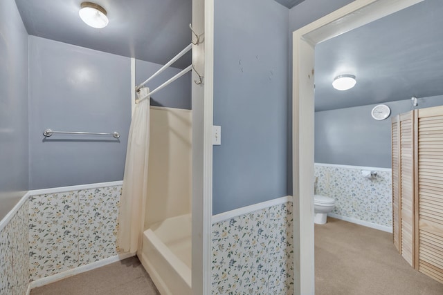 bathroom with shower / bath combo and toilet