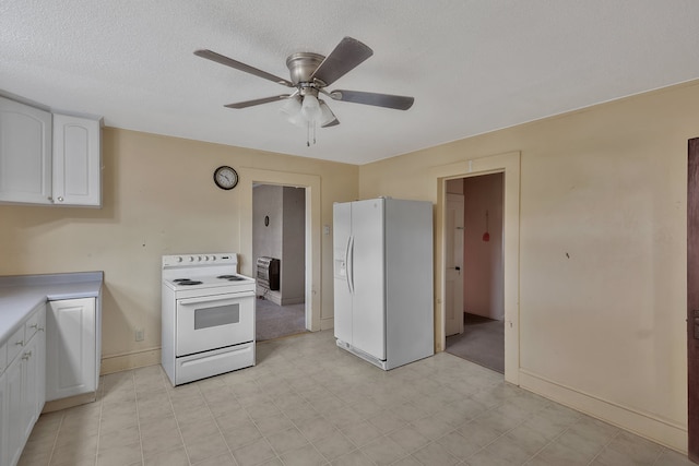 kitchen featuring a textured ceiling, white appliances, white cabinetry, and ceiling fan