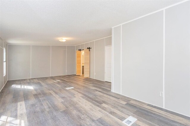 182 Poplar Springs Dr, Easley, SC 29642 - empty room featuring wood finished floors and a textured ceiling