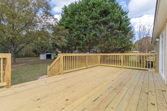 deck featuring a storage shed and a lawn