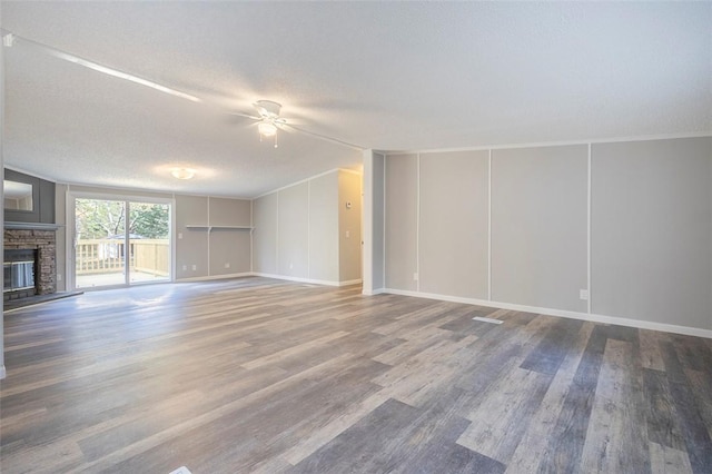 182 Poplar Springs Dr, Easley, SC 29642 - unfurnished living room with a ceiling fan, wood finished floors, a textured ceiling, a fireplace, and baseboards