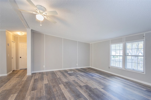 empty room with a textured ceiling, ceiling fan, ornamental molding, and dark wood-type flooring