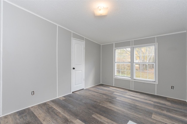 unfurnished room featuring a textured ceiling, dark hardwood / wood-style flooring, and crown molding