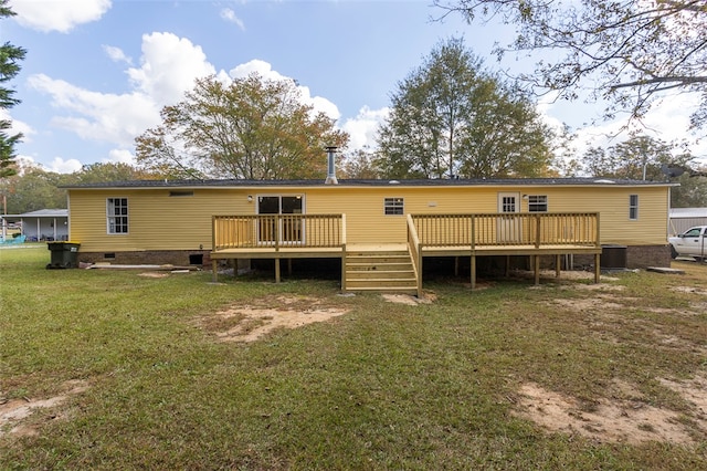 rear view of property featuring central AC, a yard, and a deck