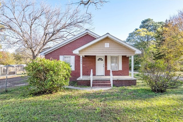 bungalow with a front lawn and covered porch