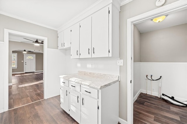 kitchen with ceiling fan, dark hardwood / wood-style flooring, white cabinetry, and crown molding