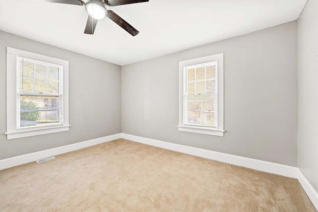 unfurnished room featuring ceiling fan and light colored carpet