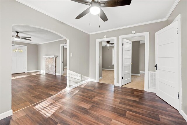 empty room with crown molding, ceiling fan, and dark hardwood / wood-style floors