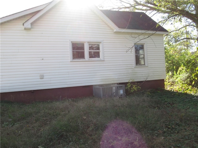 view of side of property featuring central air condition unit