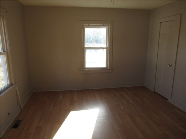 spare room featuring dark wood-type flooring