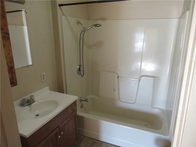 bathroom featuring tile patterned flooring, vanity, and  shower combination