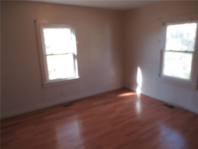 unfurnished room featuring dark wood-type flooring