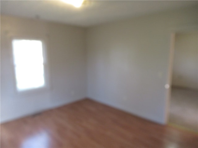 spare room with hardwood / wood-style floors