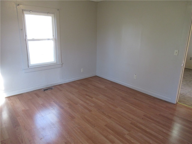 unfurnished room with light wood-type flooring