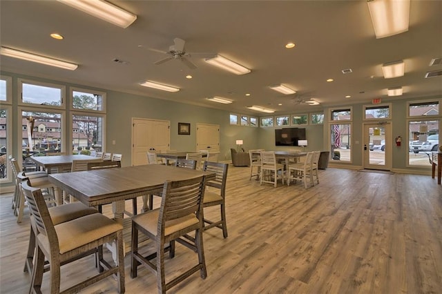 dining space with light wood-type flooring and ceiling fan