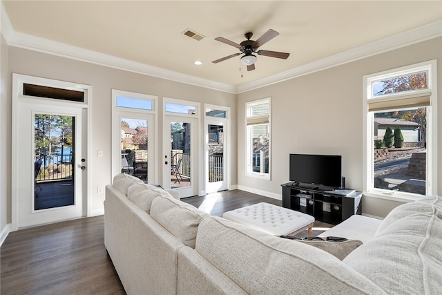 living room with ceiling fan, plenty of natural light, dark hardwood / wood-style floors, and ornamental molding