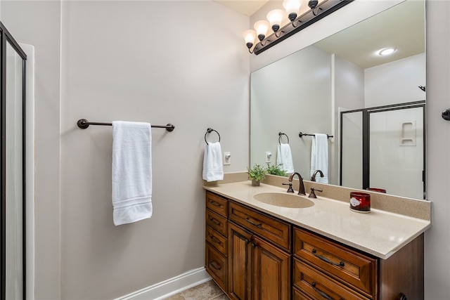 bathroom featuring tile patterned flooring, vanity, and a shower with shower door