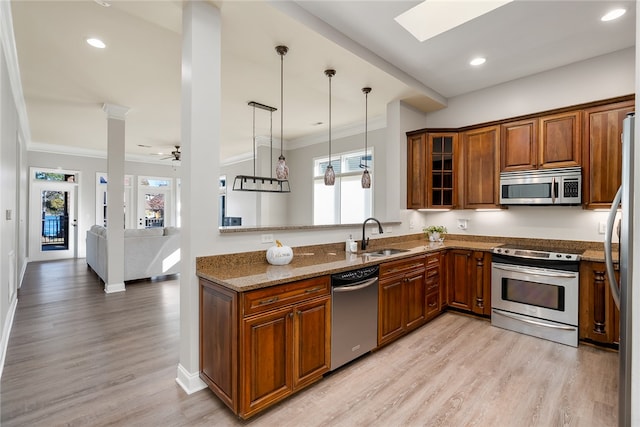 kitchen featuring ceiling fan, sink, light hardwood / wood-style flooring, and appliances with stainless steel finishes