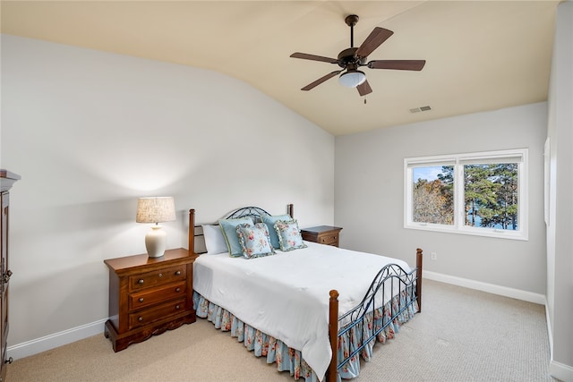 bedroom with ceiling fan, light carpet, and vaulted ceiling