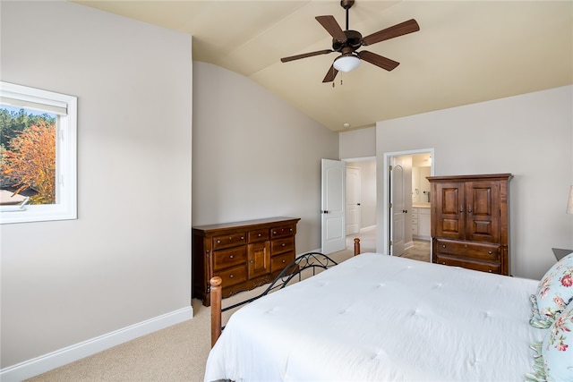 carpeted bedroom with connected bathroom, ceiling fan, and lofted ceiling