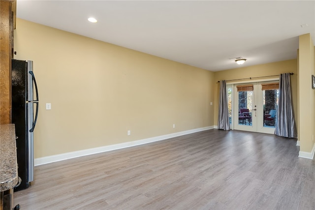 interior space with light hardwood / wood-style floors and french doors