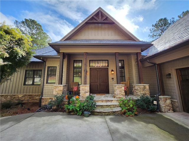 view of exterior entry featuring covered porch