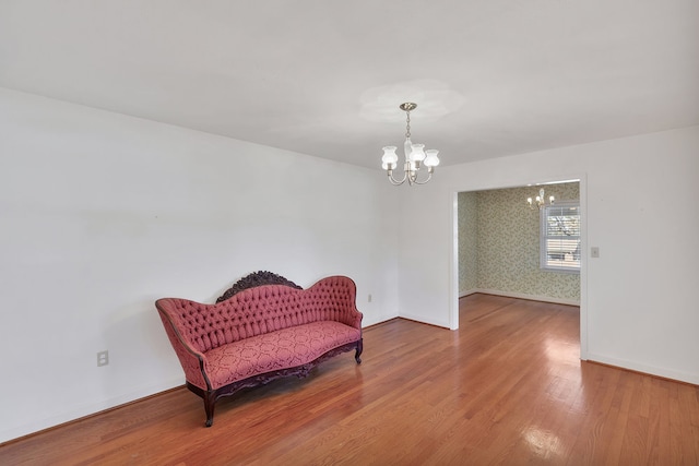 sitting room featuring hardwood / wood-style floors and a notable chandelier