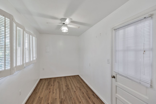 spare room with ceiling fan and dark hardwood / wood-style flooring