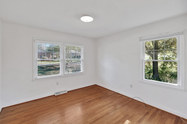 unfurnished room with light hardwood / wood-style floors