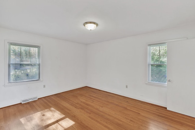 unfurnished room with light hardwood / wood-style floors