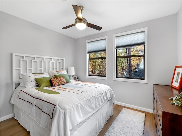 bedroom with ceiling fan and hardwood / wood-style floors