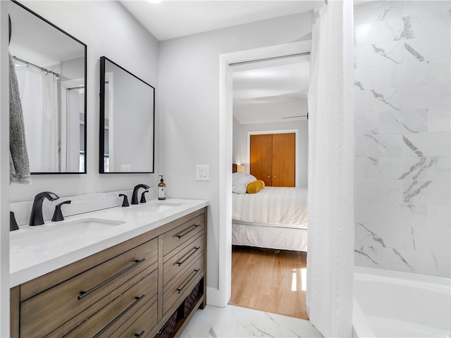 bathroom with vanity, wood-type flooring, and shower / tub combo