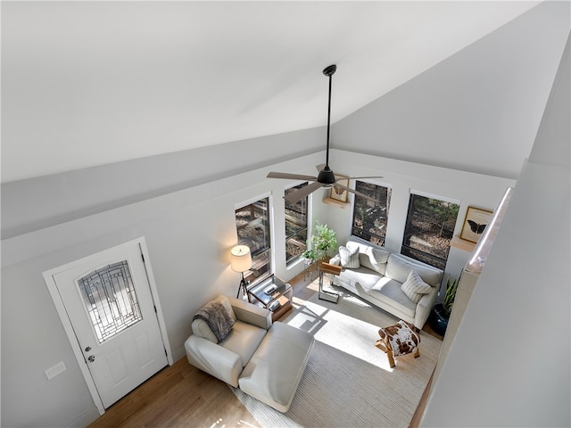 living room featuring hardwood / wood-style floors, lofted ceiling with beams, a healthy amount of sunlight, and ceiling fan