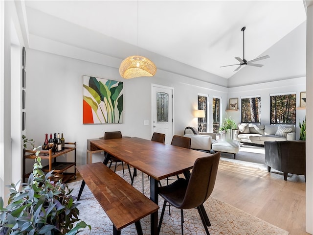 dining area featuring ceiling fan, light hardwood / wood-style floors, and lofted ceiling