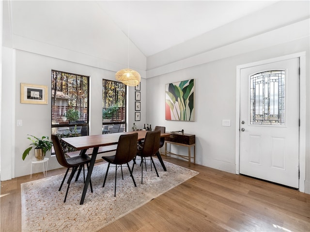 dining room featuring hardwood / wood-style floors and vaulted ceiling