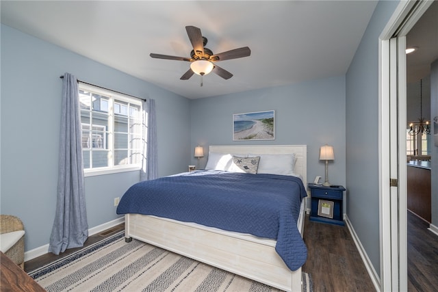 bedroom with ceiling fan and dark hardwood / wood-style flooring