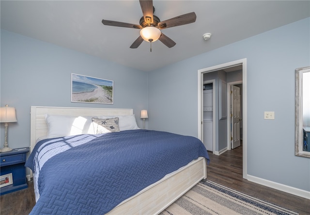 bedroom with ceiling fan, dark hardwood / wood-style flooring, a spacious closet, and a closet