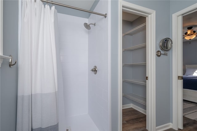 bathroom with wood-type flooring and curtained shower