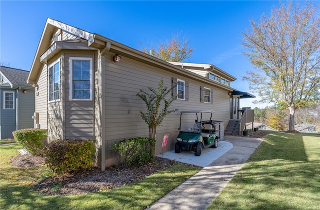 view of side of property with a lawn