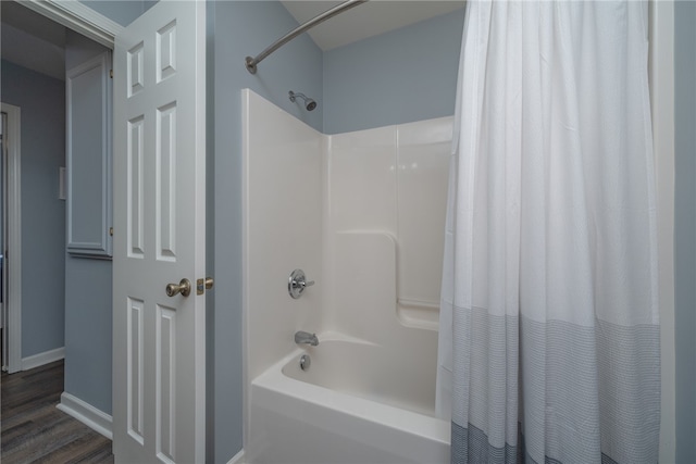 bathroom with hardwood / wood-style flooring and shower / bath combination with curtain