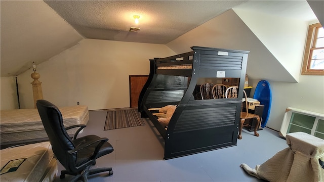 bedroom featuring a textured ceiling, concrete flooring, and lofted ceiling