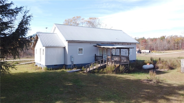 rear view of property with a yard