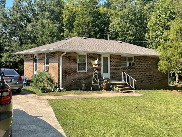 single story home featuring cooling unit and a front yard