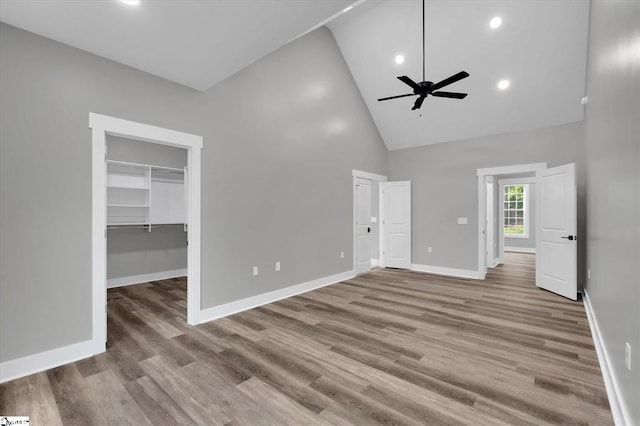 interior space featuring ceiling fan, high vaulted ceiling, and light hardwood / wood-style flooring