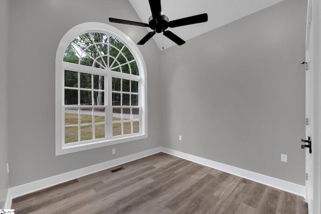 empty room featuring ceiling fan, lofted ceiling, and light hardwood / wood-style flooring