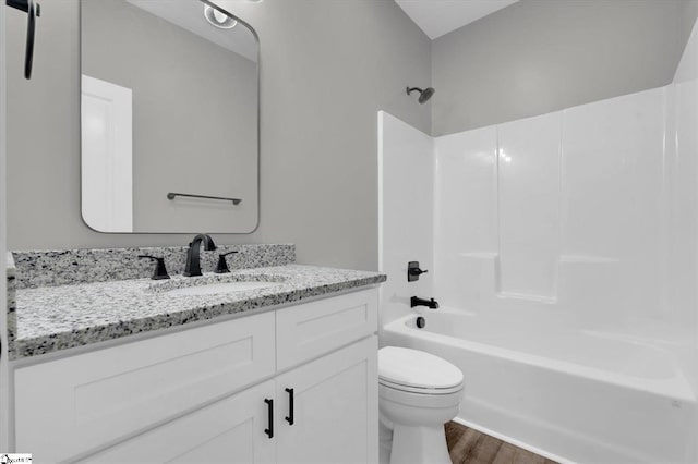 full bathroom featuring vanity, toilet, shower / bathing tub combination, and hardwood / wood-style flooring