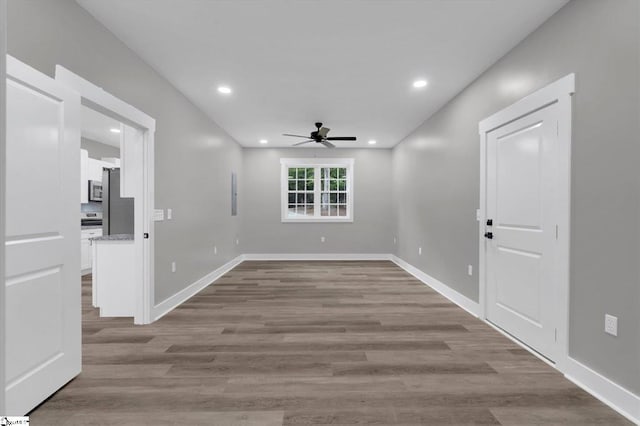 interior space with ceiling fan and light hardwood / wood-style floors