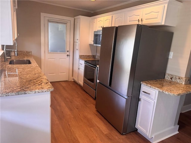 kitchen with sink, white cabinets, stainless steel appliances, light stone countertops, and light wood-type flooring