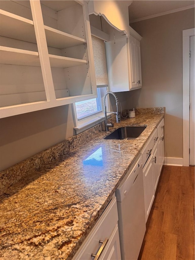 kitchen featuring sink, dark wood-type flooring, white cabinetry, white dishwasher, and light stone countertops