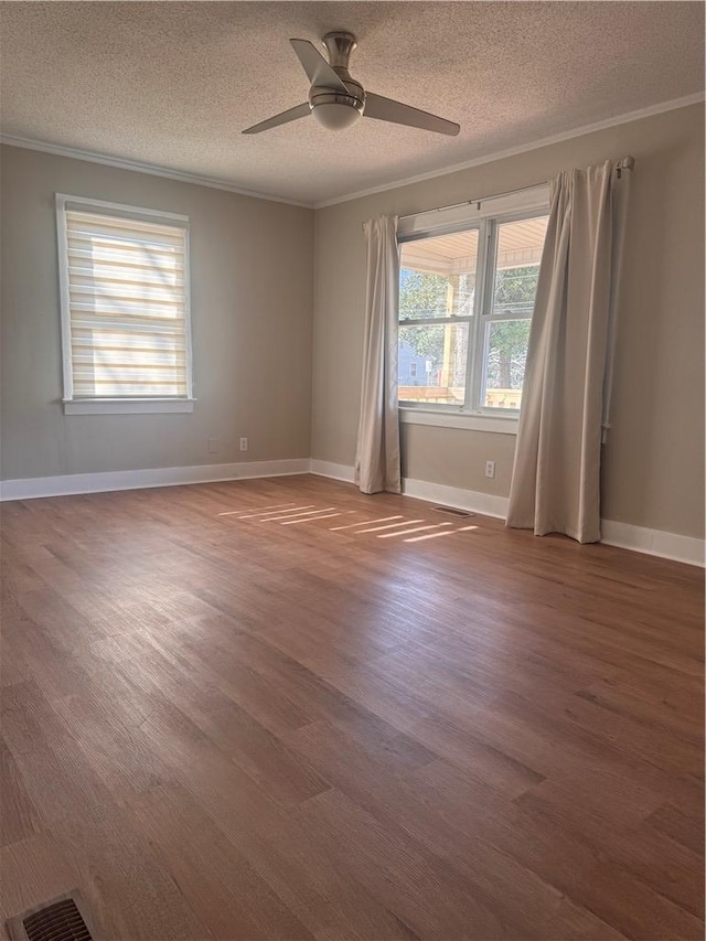 unfurnished room with hardwood / wood-style flooring, ceiling fan, ornamental molding, and a textured ceiling